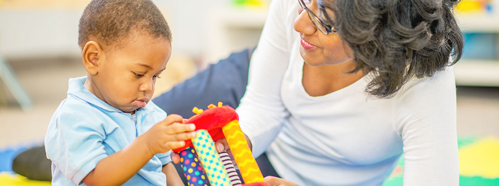 Liberty Post NY Early Intervention Program, mother and son playing with toy