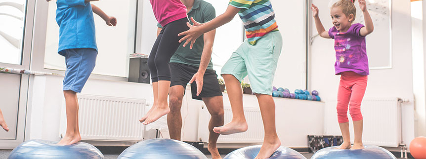 Liberty Post NY Sensory Gym, Children jumping onto exercise balls, improving their fundamental skills